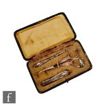 An early 20th Century etui, the rounded rectangular case containing a white metal needle case,