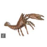 A Japanese cast metal bronzed figure of a cray fish, modelled with pincers raised, seal mark to