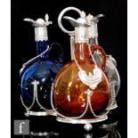 A set of three 19th Century flagons in clear, amber and blue glass, of globe and shaft form with