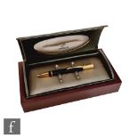 A boxed Parker Duofold ball point pen in black with 23k gold plated trim.