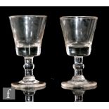 A pair of 19th Century drinking glasses circa 1820, the bucket bowls above a medial and basal