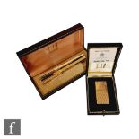 A cased Dunhill 70 gold plated lighter with instruction booklet, with a cased Dunhill fountain pen