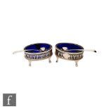 A pair of Victorian hallmarked silver oval open salts, each raised on four strut feet below a