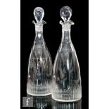A pair of 19th Century glass decanters of club form, each with basal fluting and facet cut necks,