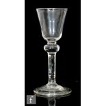 An 18th Century wine glass circa 1750, the pointed round funnel bowl with basal nipple, above stem