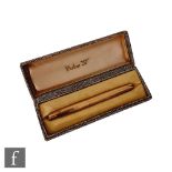 A cased 9ct hallmarked Parker 51 fountain pen with engine turned decoration and engraved initials