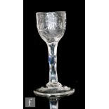 An 18th Century Jacobite type wine glass circa 1785, the round funnel bowl engraved with a rose in