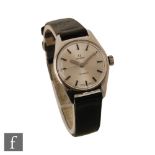 A lady's stainless steel Omega Geneve manual wind wrist watch, batons to a circular silvered dial,