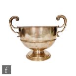 A hallmarked silver twin handled bowl, stepped circular base below plain body terminating in twin