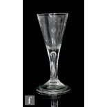 An 18th Century wine glass circa 1740, the drawn trumpet bowl above a teared stem, raised to a