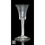 An 18th Century wine glass, circa 1745, the waisted bell bowl above a multiple spiral air twist stem