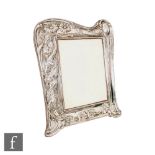 An Art Nouveau hallmarked silver rectangular easel photograph frame with one side decorated with a