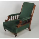 A Biedermiere type Armchair, of low proportions in satin mahogany with carved rails and legs,