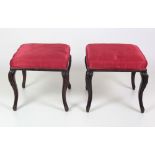 An attractive pair of Victorian Foot Stools, covered in red silk material on carved cabriole legs.