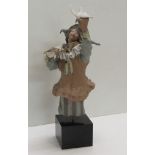 An unusual Lladro Figure of a Jester or Pierrot, with dove in hand, in typical pose,
