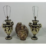 A pair of large porcelain Table Lamps, the dark ground decorated in cream with embossed figures,
