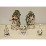 A pair of matching porcelain Figures, Lady & Gent, each seated by a balustrade,