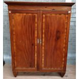 A 19th Century two door Wardrobe, the cornice with Greek key moulding,