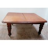 A large Victorian mahogany Dining Table (dismantled) with two spare leaves on heavy turned and
