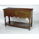 A small oak Dresser Base / Sideboard, the rectangular top with moulded edge,