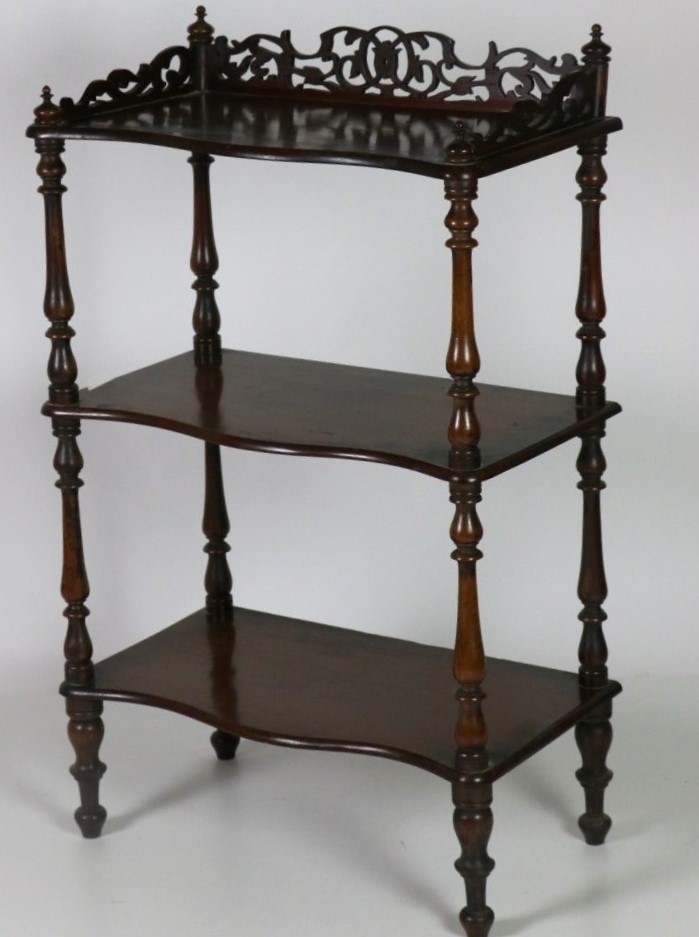 A Victorian walnut three tier Whatnot, with carved and pierced gallery,