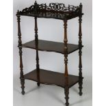 A Victorian walnut three tier Whatnot, with carved and pierced gallery,
