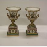 A pair of attractive Derby cream ground colourful two handled Urns on Stands,