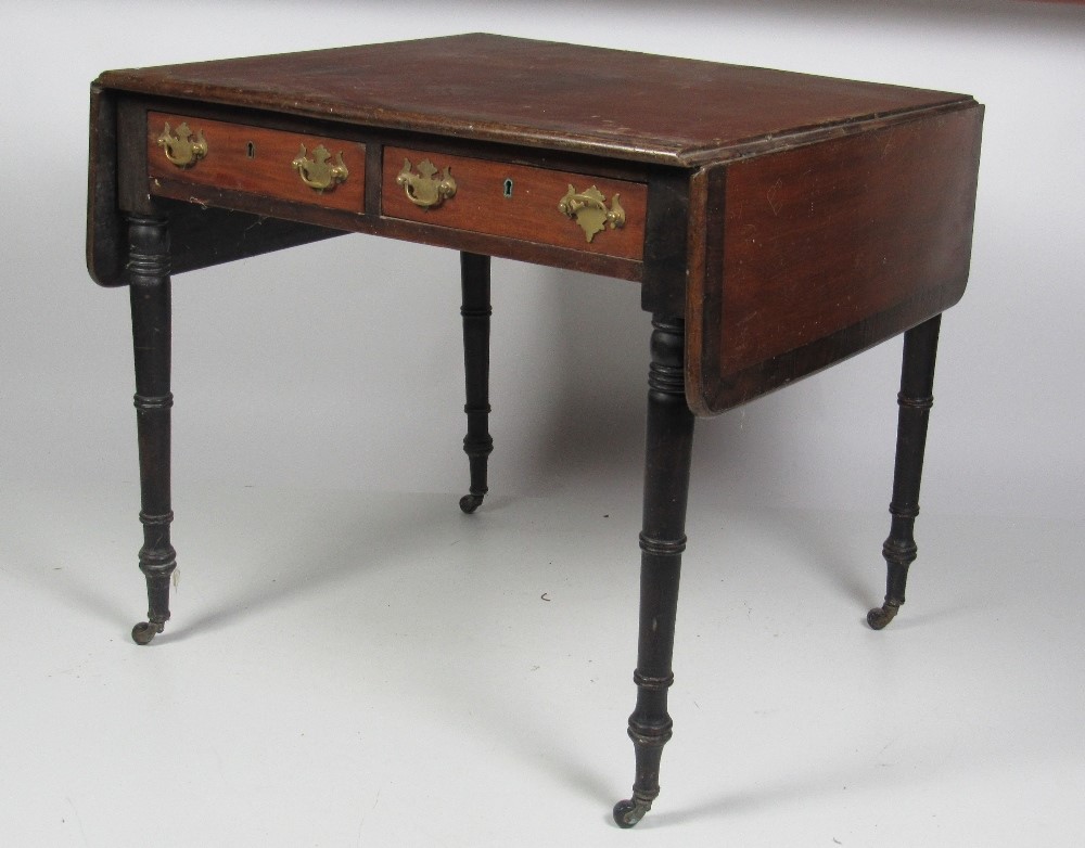 An early 19th Century mahogany Sofa Table, with crossbanded top, two small frieze drawers,