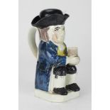 An important 18th Century earthenware Toby Jug, decorated with semi translucent coloured glazes,