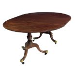 An early 19th Century mahogany two pod Dining Table, and extra leaf,