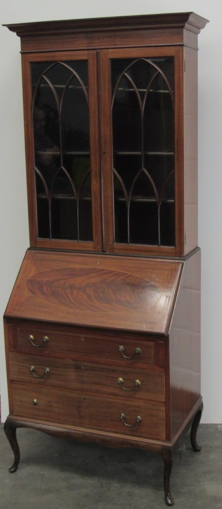 An Edwardian slope front Bureau, with fitted interior above three drawers raised on cabriole legs,