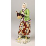 An attractive Chelsea porcelain Figure of Female Bottle Seller, in colourful attire,