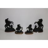A pair of Spelter Marley Horses, after Consteau, together with a smaller pair, on wooden bases.