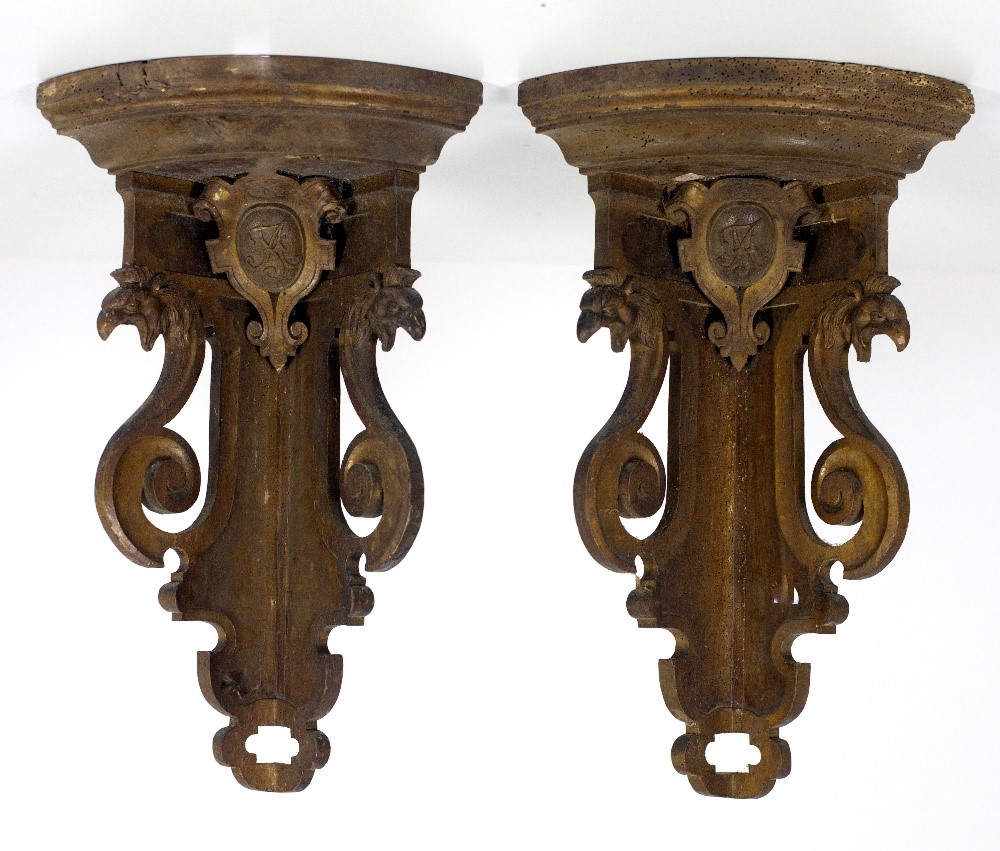 A pair of carved and pierced gilt heightened Corner Brackets, decorated with bird head and crests,