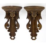 A pair of carved and pierced gilt heightened Corner Brackets, decorated with bird head and crests,