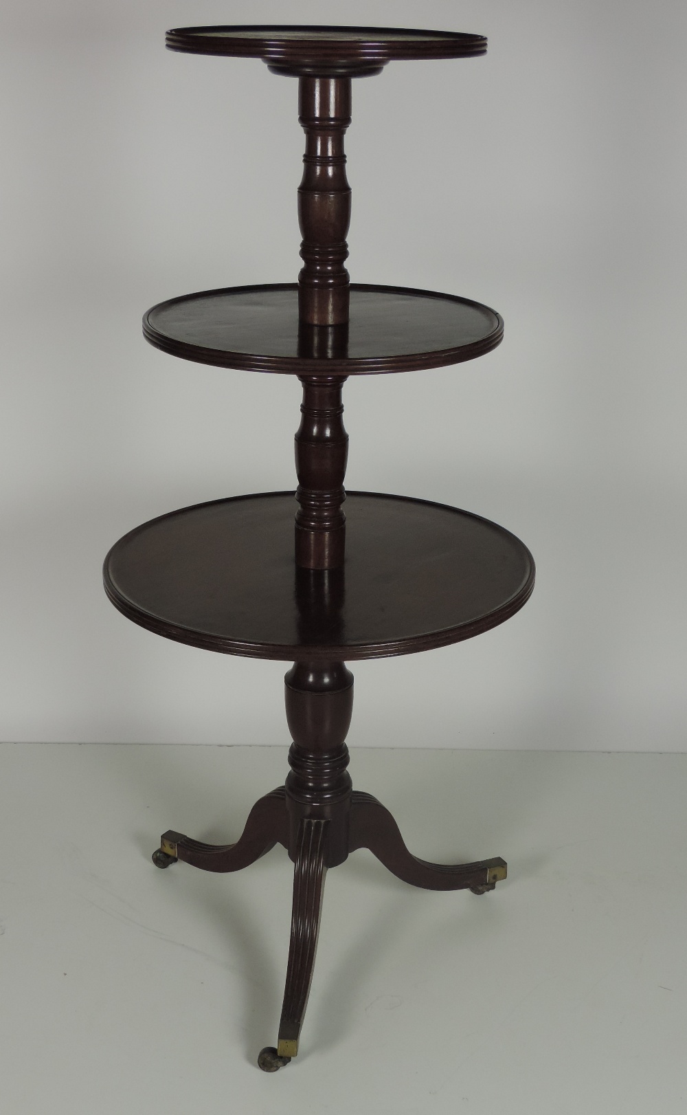 A late Georgian period circular mahogany three tier Dumbwaiter,