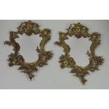 A pair of oval shaped heavy gilt brass Wall Mirrors, in the rococo style.