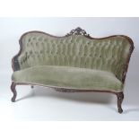 An early Victorian period walnut deep buttoned Settee,