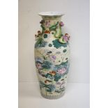 A large Chinese oversized cream ground Vase, designed with flowers, fish and birds,