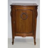 A large Edwardian mahogany Music Cabinet, the single panel door and sides with carved decoration.
