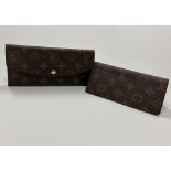 A leather Purse, with LV monogram and ty