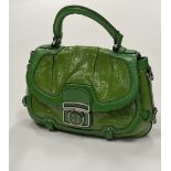 A green leather Handbag, by Celine bearing logo "Celine," on interior,
