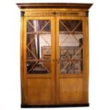 An important Regency period satinwood Wardrobe, in the manner of George Bullock,