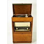 A mahogany cased Gerrard Radiogram, radio cum record player, plus record holder.