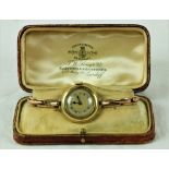 A Ladies 9ct gold Wrist Watch, with expanding gold bracelet, in leather box.