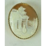 A very fine gold carved Cameo Brooch, of "A Woman standing outside a House," with safety chain.