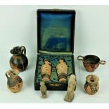 A collection of varied Greek and Egyptian Ceramics, including a case housing two early Ewers,
