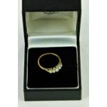 An 18ct gold Ring, with five graduating pearls, set with .1ct of diamond chips, size L 1/2.
