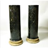 A pair of 19th Century assimilated black marble Plinths, on circular white bases,