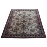 A large ivory ground wool Carpet, with stylized designs inside a multi-band border,